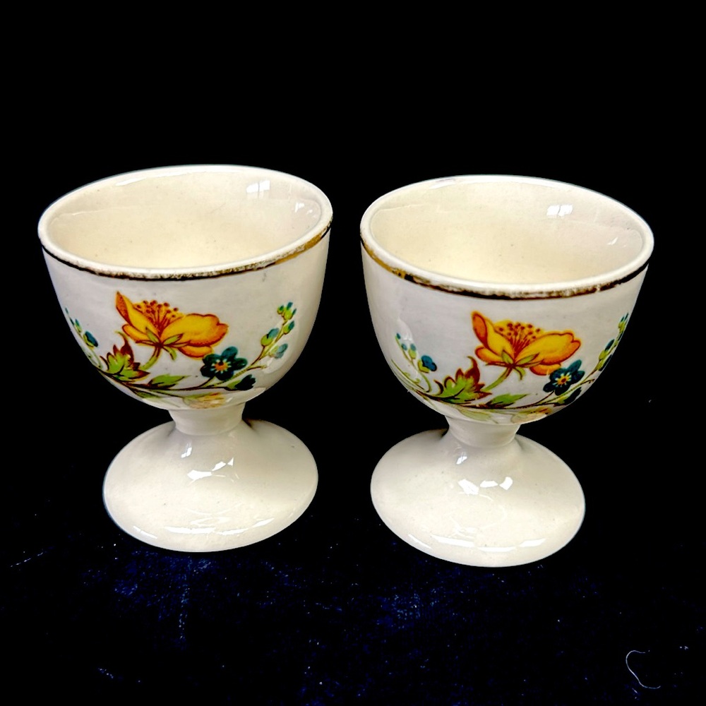 Vintage 2 1/4” set of 2 porcelain gold rimmed with  buttercups design egg cups